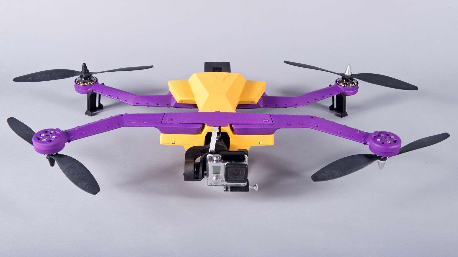 follow drones by airdog features a yellow and purple drone on a floor