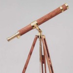 telescopes by glass eye shows a brass wood telescope with a grey background