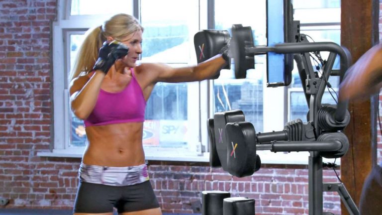 home fitness by nexersys shows a woman punching an exercise machine
