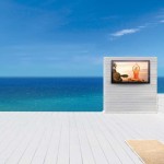 televisions by Séura Storm Weatherproof TV on a luxury patio with the ocean as a background