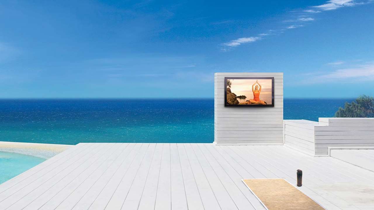 televisions by Séura Storm Weatherproof TV on a luxury patio with the ocean as a background