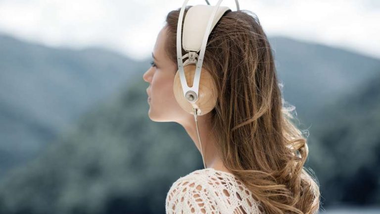headphone by meze with a woman listening to music while admiring nature