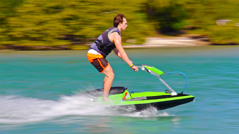 jet ski by Bomboard man on a body of water on a lime green jet ski