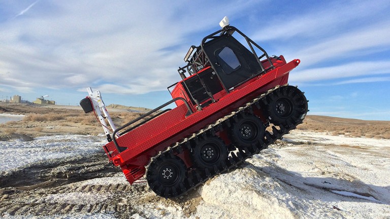 amphibious vehicles by HYDRATREK a red vehicle going over a mound of sand
