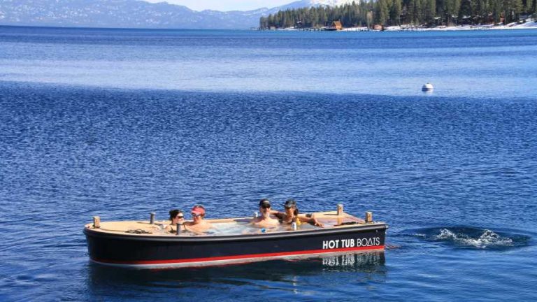 Hot Tub Boats boat floating in a body of water with passengers