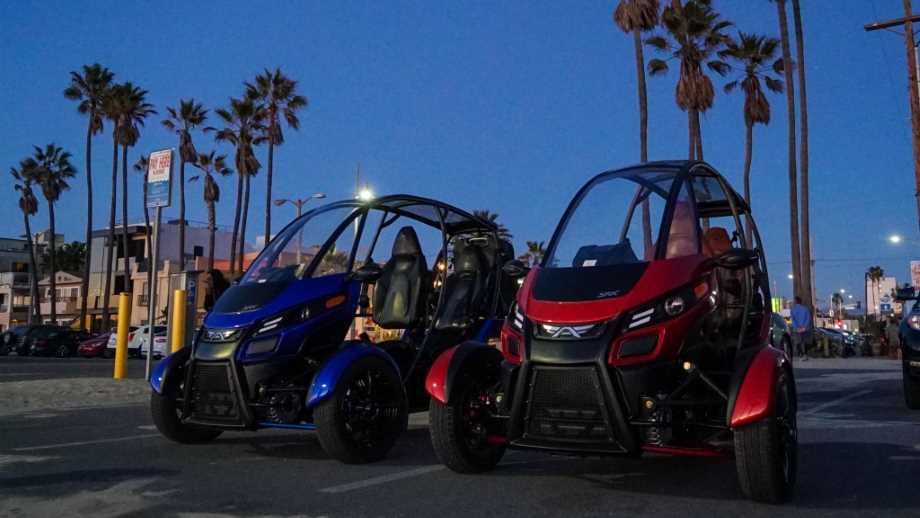 Arcimoto electric vehicles a red and blue electric vehicle parked on a street in california