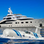 luxury submarines in the ocean next to a yacht in the ocean