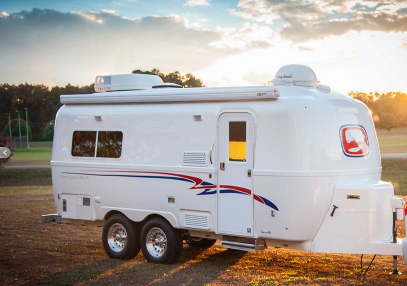 camping a white camper by Oliver Travel Trailers
