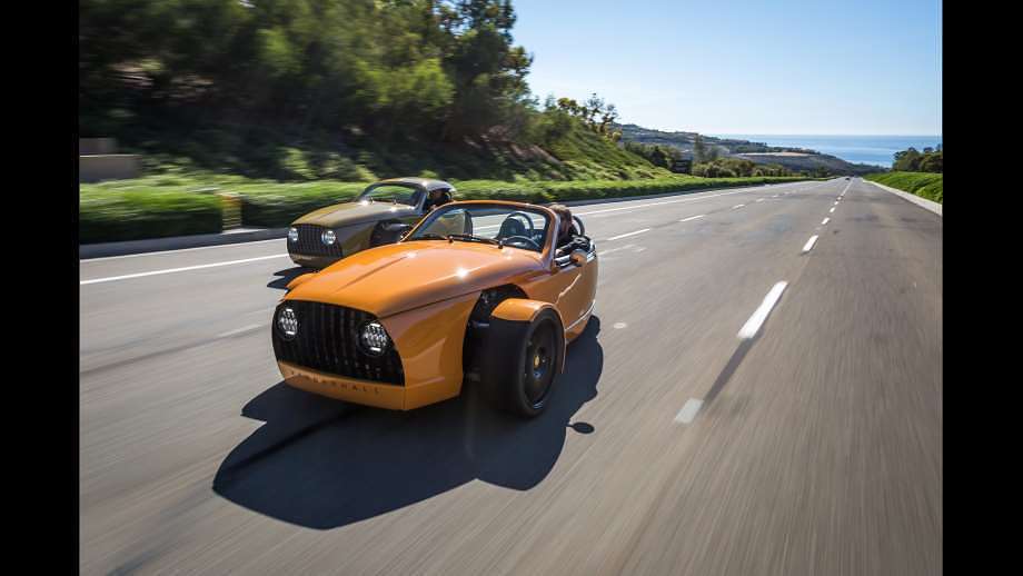 Small electric vehicles featuring an orange roadster by Vanderhall