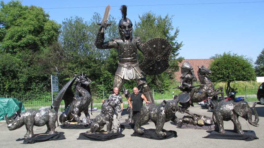 art by recycle art features a warrior and several other statues made from used automotive parts