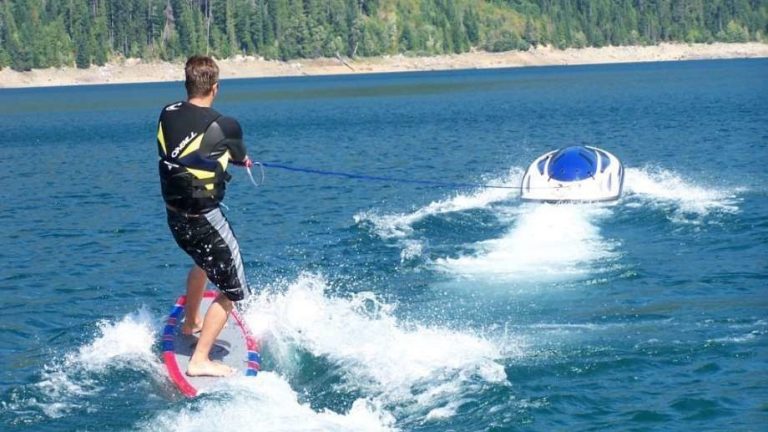 luxury water toy by solo ski machine features man skiing behind the solo on a body of water