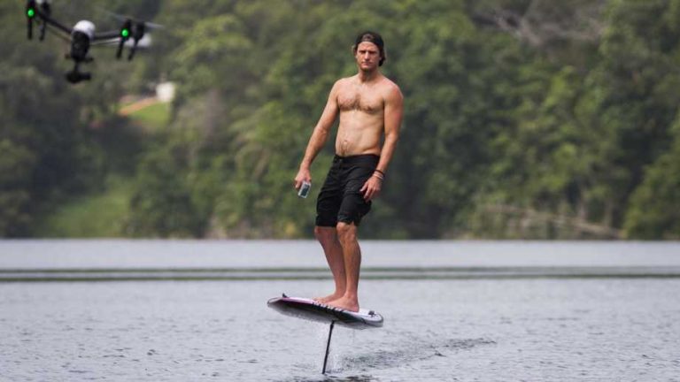 efoil surfboard by lift foils on a body of water with a drone and a mountain