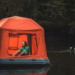 Floating tents by smithfly on the water with a paddleboarder